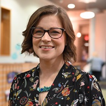 Image of a white woman in a space top inside