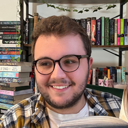 Image of a white man with glasses against book shelves