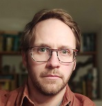Head shot of a white man in glasses