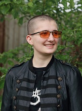 Photo of author in orange glasses on green