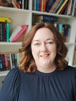 Image of a white woman against bookshelves