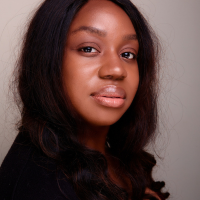 Head shot of a Black woman against grey