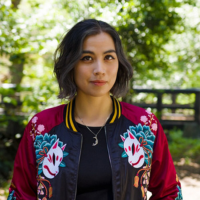 Photo of a woman in an embroidered jacket outside