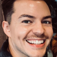 Headshot of a white man with a small moustache