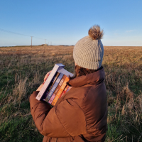photo of a woman in a hat turned away from the camera