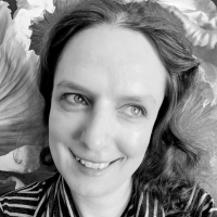 Black and white headshot of a white woman with dark hair