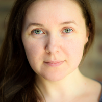 Headshot of a white woman with dark hair