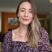 Head shot of a white woman with long blonde hair indoors