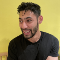 Photo of a man in a black shirt on a yellow background