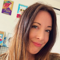 Headshot of a white woman with long brown hair indoors