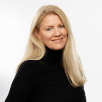 Headshot of a white woman with blonde hair against white