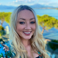 Headshot of a white woman with blonde hair outside