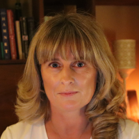 Headshot of a white woman with blonde hair indoors