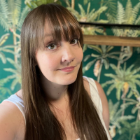 Headshot of a white woman with long brown hair indoors