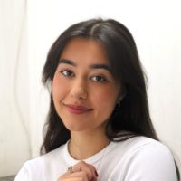 Headshot of a woman with long dark hair against a white background