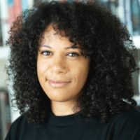 Picture of the author, Natasha Bowen, in a black top in front of a bookshelf.