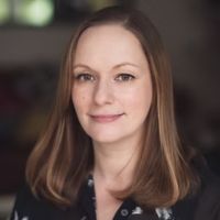 Headshot of a white woman with shoulder length brown hair