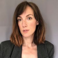 Headshot of a white woman with brown shoulder length hair