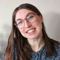 Headshot of a white author with long brown hair