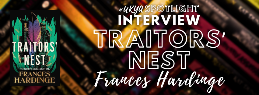 A blurred background of books, with the cover of the novel TRAITORS' NEST sat Next to White writing that says #UKYA Spotlight Interview TRAITORS' NEST Frances Hardinge