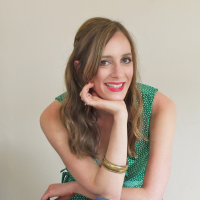Headshot of a white woman with chin on hand