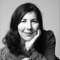 Greyscale headshot of a white woman with dark hair